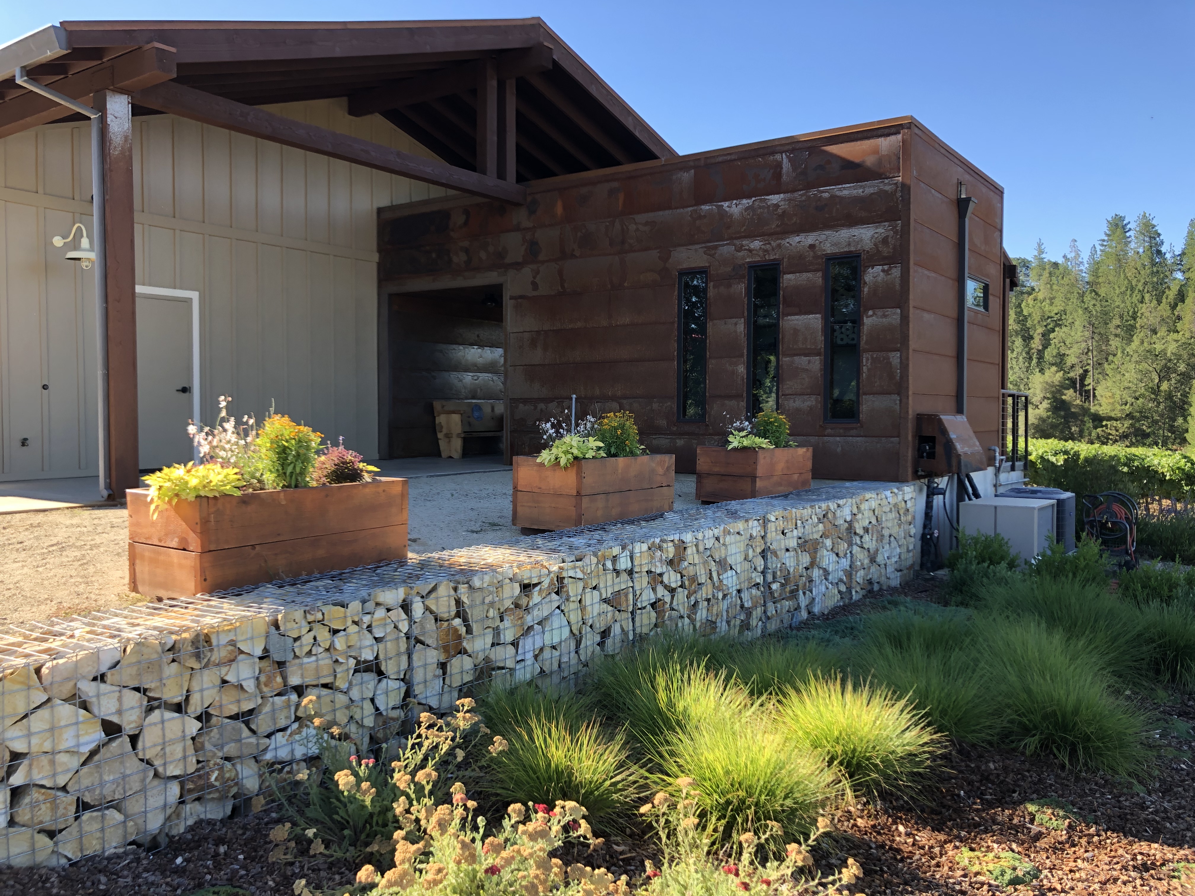 Image showing outside of Element 79 tasting room with rock foundation and rustic metal exterior.